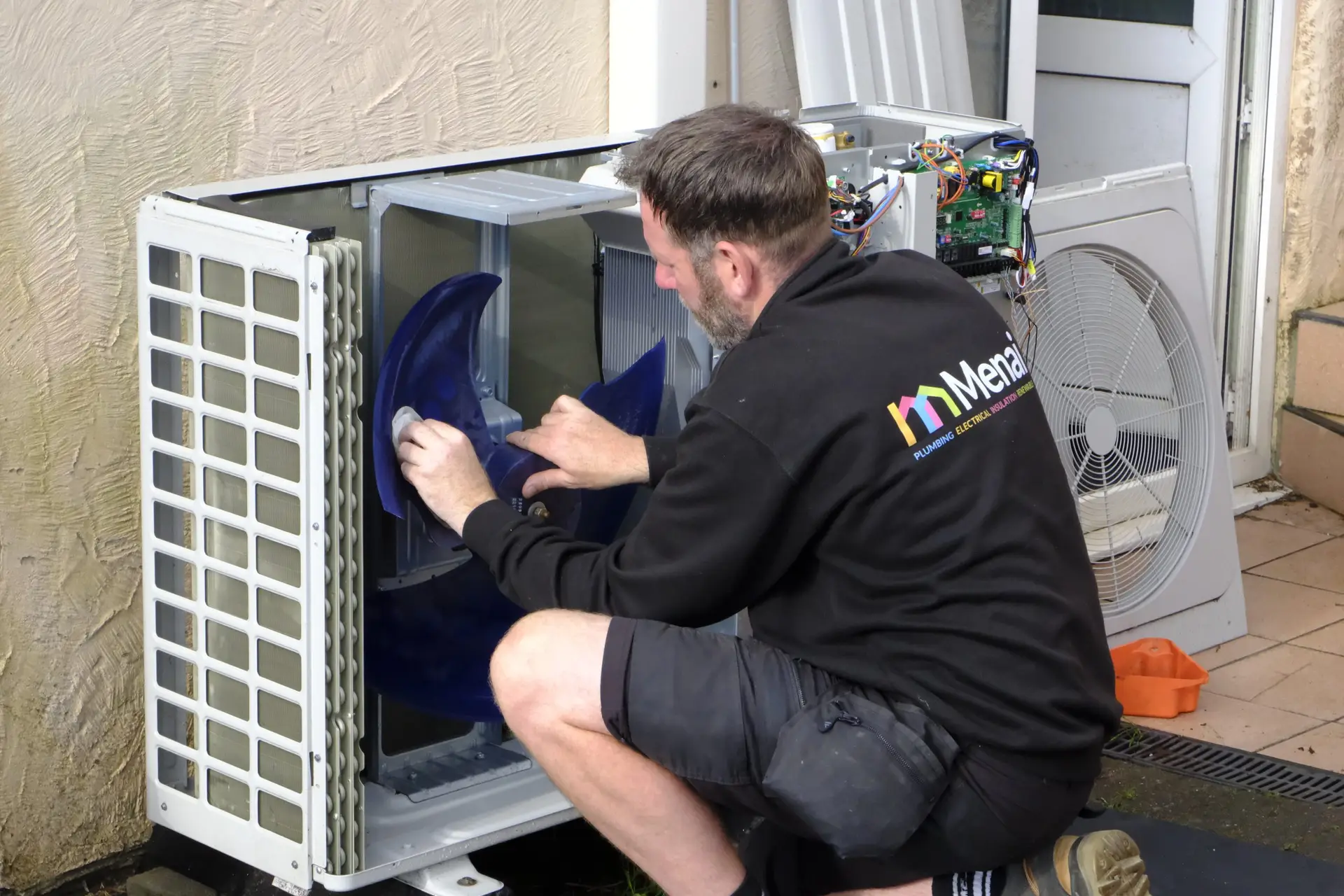 Our engineer servicing an air source heat pump