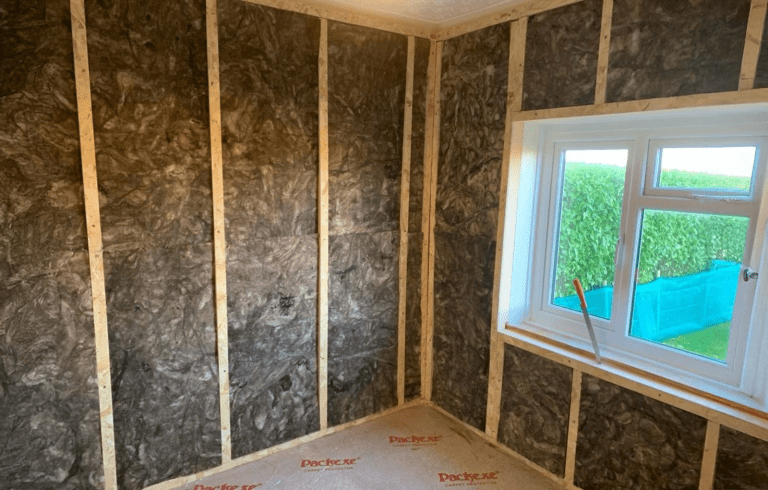 Menai fitting internal wall insulation to improve home energy efficiency.